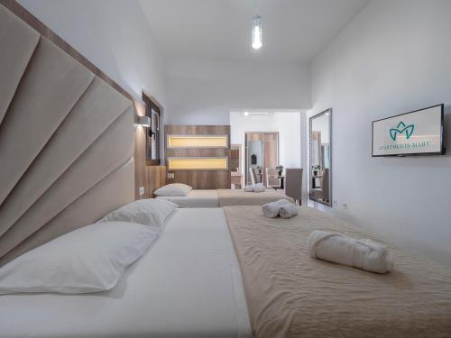 a bedroom with three beds with towels on them at Apartments Mary in Budva