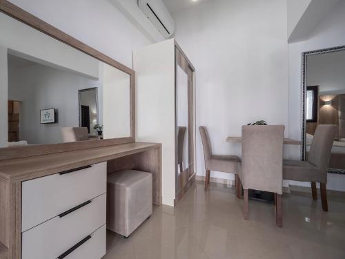 a bathroom with a mirror and a table with chairs at Apartments Mary in Budva