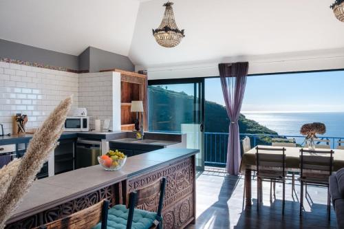 a kitchen with a view of the ocean at GuestReady - A marvellous stay in Calheta in Calheta