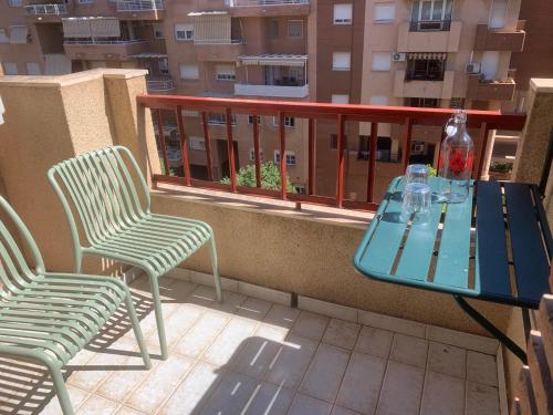 a blue table and two chairs on a balcony at Apartamento, Piccolo Mare, junto centro, vistas Sierra Nevada in Granada
