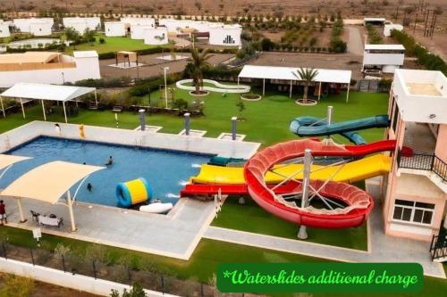 an aerial view of a water park with slides at SAJ Farm Inn in Ibrā