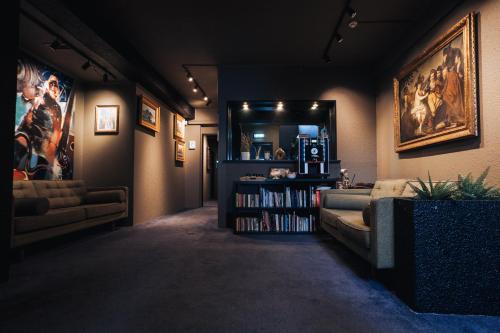 a living room with a couch and a book shelf at Brim Hotel in Reykjavík