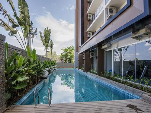 a swimming pool in the side of a building at Karon Chic Seashore Apartment in Karon Beach