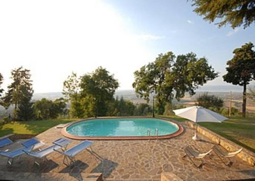 uma piscina com cadeiras e um guarda-sol em Villa Giara - Piscina vista Lago Trasimeno Umbria em Paciano