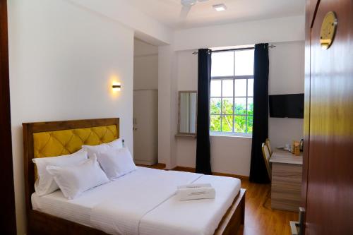 Postel nebo postele na pokoji v ubytování CROWN REGENCY- BADULLA