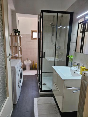 a bathroom with a shower sink and a washing machine at Palazzina al Lingotto in Turin