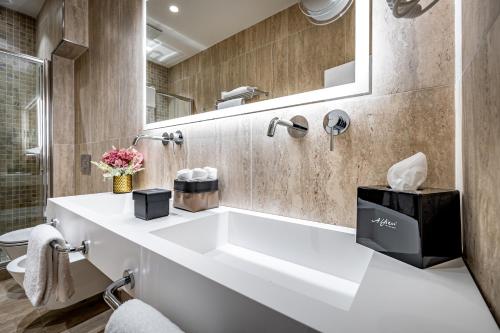 a bathroom with a white sink and a mirror at Il Rivalta - Place of Charme in Florence