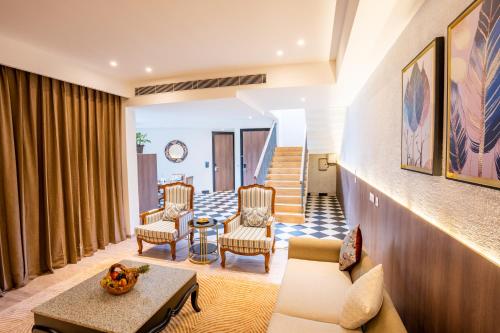 a living room with a couch and chairs at Velmore Kasauli Operated by Royal Orchid Hotel Ltd. in Kasauli