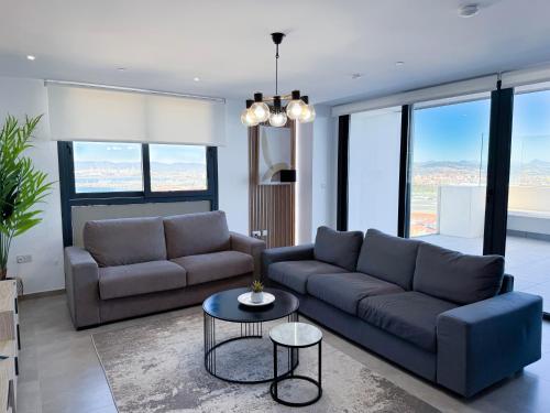 a living room with a couch and a table at E1 Suites & Spa aparthotel style - Gym & Spa in Gibraltar