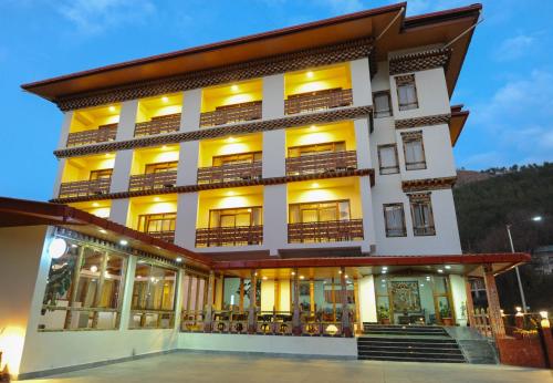 a large white building with windows and balconies at Eutsholing Boutique Hotel in Thimphu