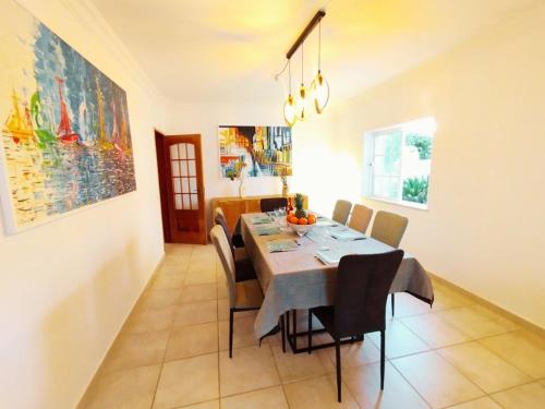 a dining room with a table and chairs at Villa Serena in Olhão