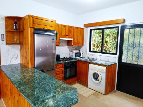 a kitchen with a refrigerator and a dishwasher at Maryloo Country House in Kakopetria