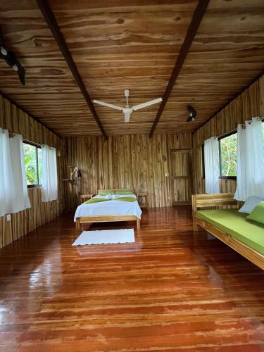 a bedroom with two beds and a wooden ceiling at Finca Kobo in Palo Seco