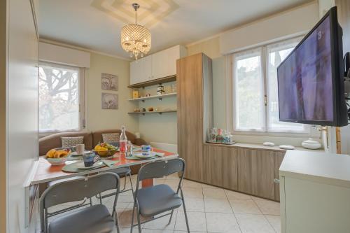 a kitchen with a table with chairs and a television at Aton House - Happy Rentals in Manerba del Garda