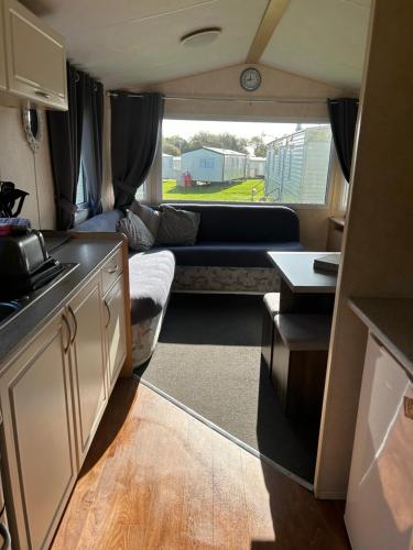 a kitchen and a living room in an rv at Northumberland Caravan Holiday in Cresswell