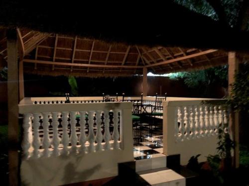a white fence in front of a patio at night at Heda House in Sanyang