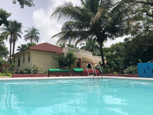 a large swimming pool in front of a house at Heda House in Sanyang