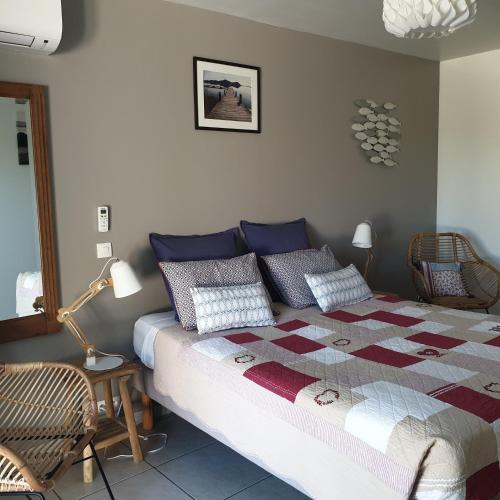 a bedroom with a bed with a quilt on it at chambres d'hôtes du moulin in Peyriac-de-Mer