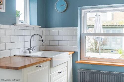 a kitchen with a sink and a window at Prince's Cottage in Deal