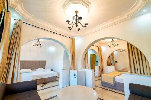 a hotel room with a bed and two mirrors at Hôtel Dar Mhana in Hammamet