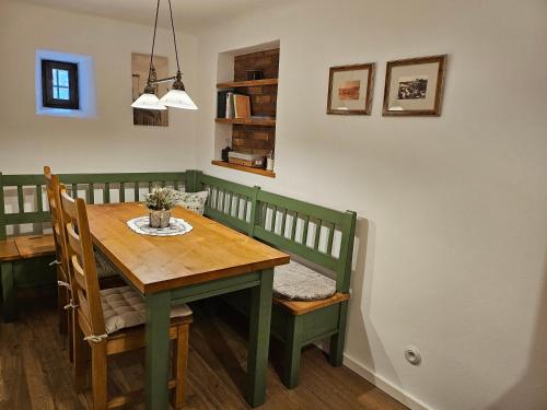 a dining room with a green table and chairs at Pension Wok in Český Krumlov