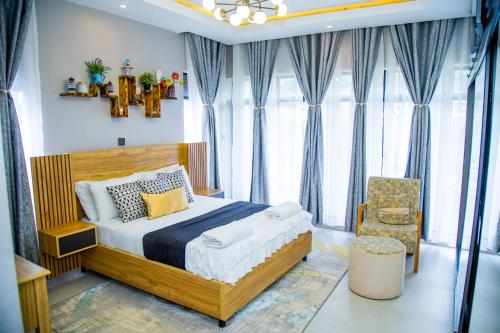 a bedroom with a bed and a chair at Casablanca in Kigali in Kigali