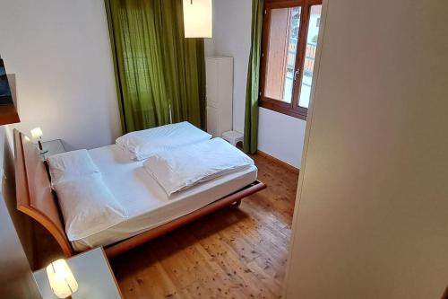 Una cama o camas en una habitación de Little apartment in Dolomiti