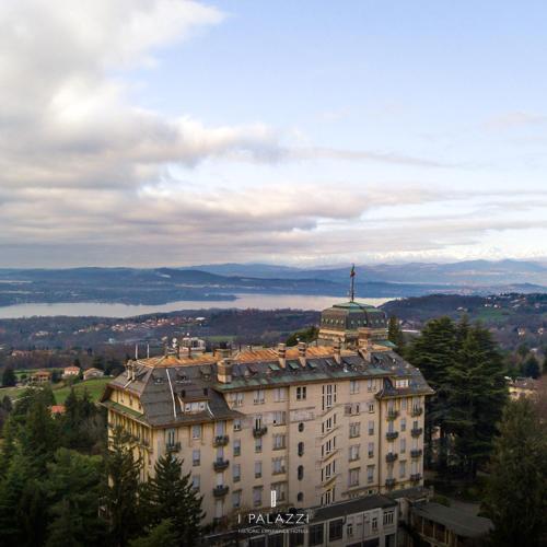 a large building with a cross on top of it at Palace Grand Hotel Varese in Varese