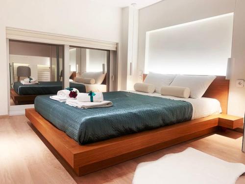 a bedroom with a large bed and a mirror at Orchid Apartments in Thermi
