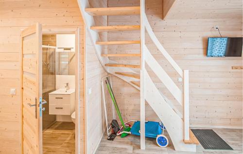 a wooden staircase in a tiny house at Cozy Home In Sarbinowo With Kitchen in Sarbinowo