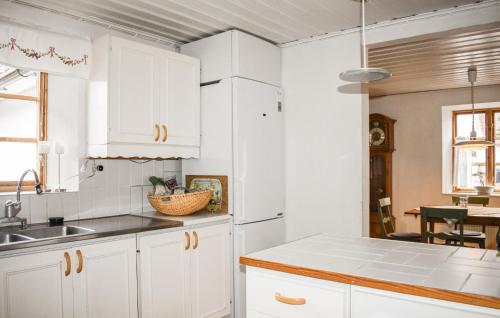 a kitchen with white cabinets and a sink at Gorgeous Home In Fjlkinge With House A Panoramic View in Fjälkinge