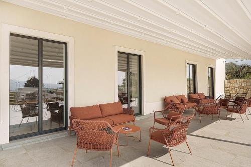 a room with chairs and couches on a patio at Giardino Delle Oche - Ocone Taburno Wine County in Ponte
