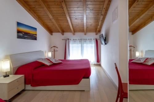 a bedroom with two beds and a window at CasaCri in Cittiglio