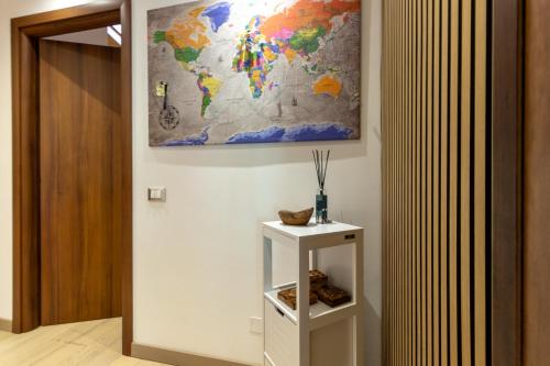 a map on the wall next to a white shelf at CasaCri in Cittiglio
