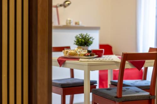a table and chairs with a plate of food on it at CasaCri in Cittiglio