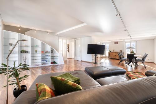a living room with a couch and a table at Familienferienwohnung HEIMat in Bludenz