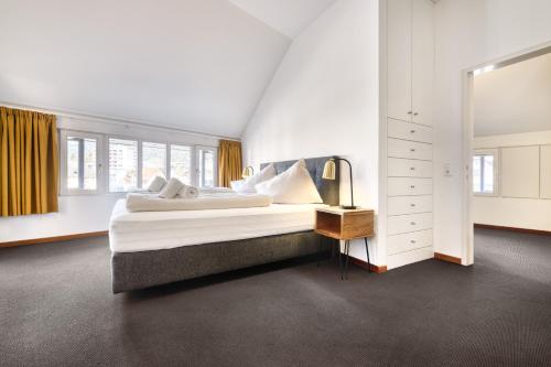 a bedroom with a large bed and a mirror at Familienferienwohnung HEIMat in Bludenz