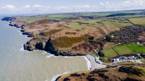 an aerial view of the ocean and a beach at Caerhafod Llangrannog in Llanllwchaiarn