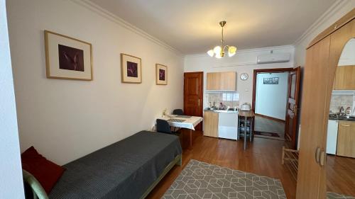 a small bedroom with a bed and a kitchen at Apartman Danka in Bük