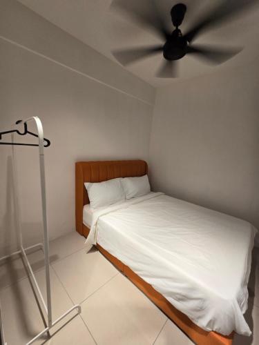 a bedroom with a bed with a ceiling fan at Manhattan Condomium Water Park Land @ Ipoh in Ipoh