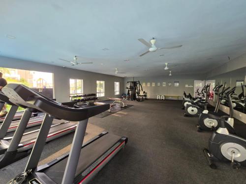 a gym with a lot of treadmills and machines at Manhattan Condomium Water Park Land @ Ipoh in Ipoh