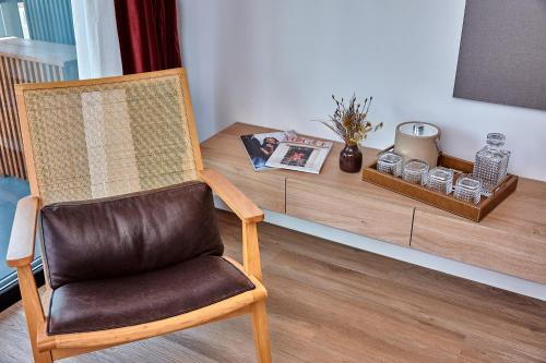 a brown chair sitting in front of a table at Babel Arcos in Buenos Aires