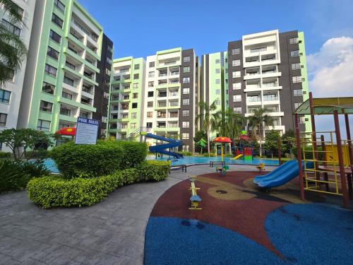 a playground in front of some tall buildings at Manhattan Condomium Water Park Land @ Ipoh in Ipoh