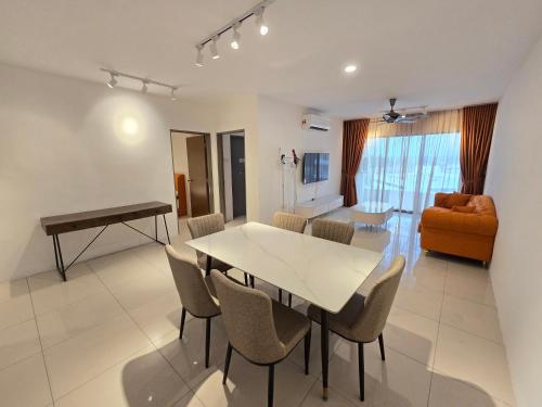 a living room with a table and chairs and a couch at Manhattan Condomium Water Park Land @ Ipoh in Ipoh