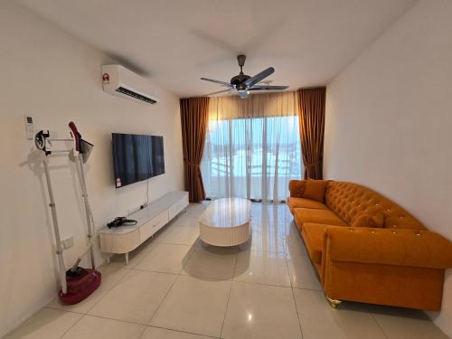 a living room with a couch and a flat screen tv at Manhattan Condomium Water Park Land @ Ipoh in Ipoh