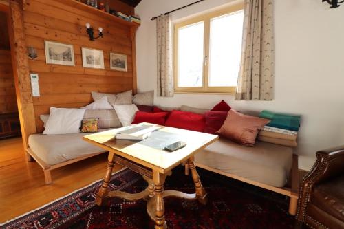 a living room with a couch and a table at Haus Haemmerle mit Ski in - Ski out in Damuls