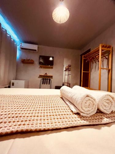 a bedroom with a bed with towels on it at Martinelli Residence in Fernando de Noronha