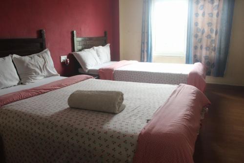 Cama o camas de una habitación en Hotel Holidays Inn - Bagpacker's Home