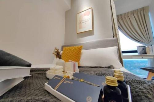 a bedroom with a bed with a book on it at Pavilion Bukit jalil Walking Distance 2 Bedroom 2-4Pax in Kuala Lumpur