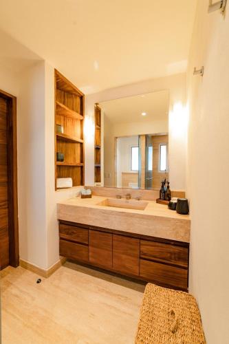 a bathroom with a large tub and a large mirror at 1013 - Villa Maya in Santa Cruz Huatulco